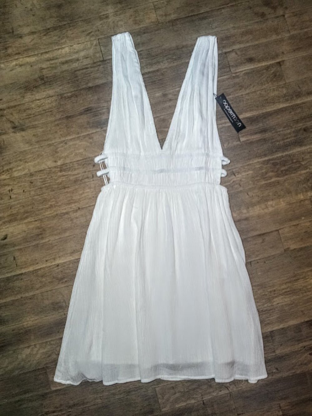 Small white mini dress cut out side detail